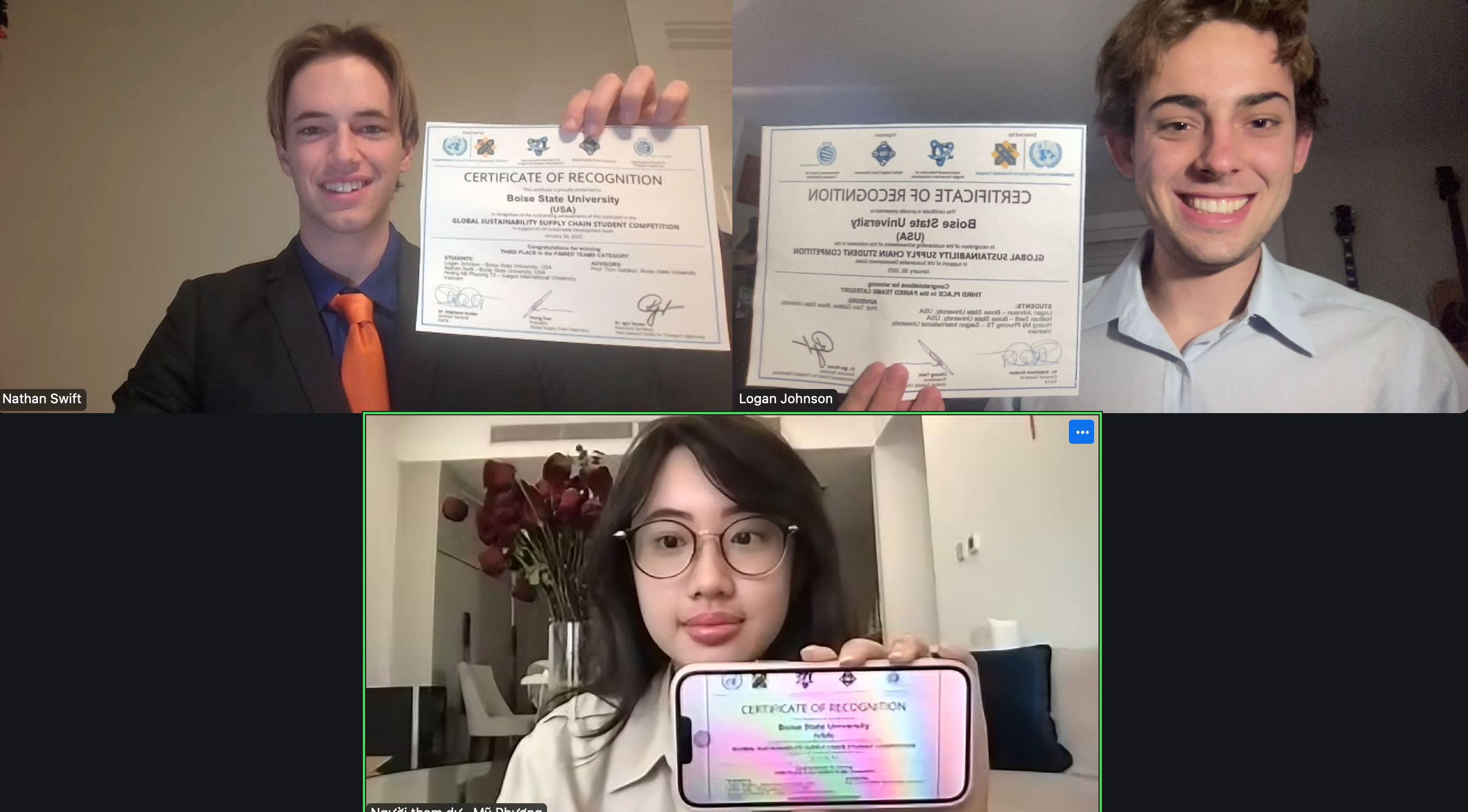 Students hold awards up to their cameras in a video calll